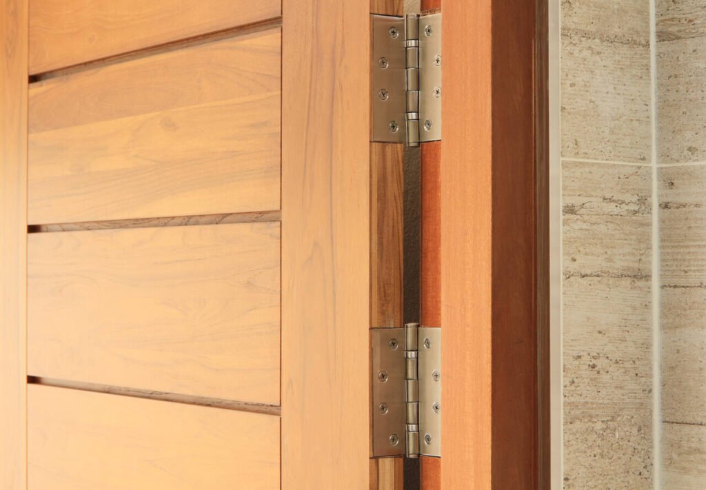 Stainless door hinges on wooden door